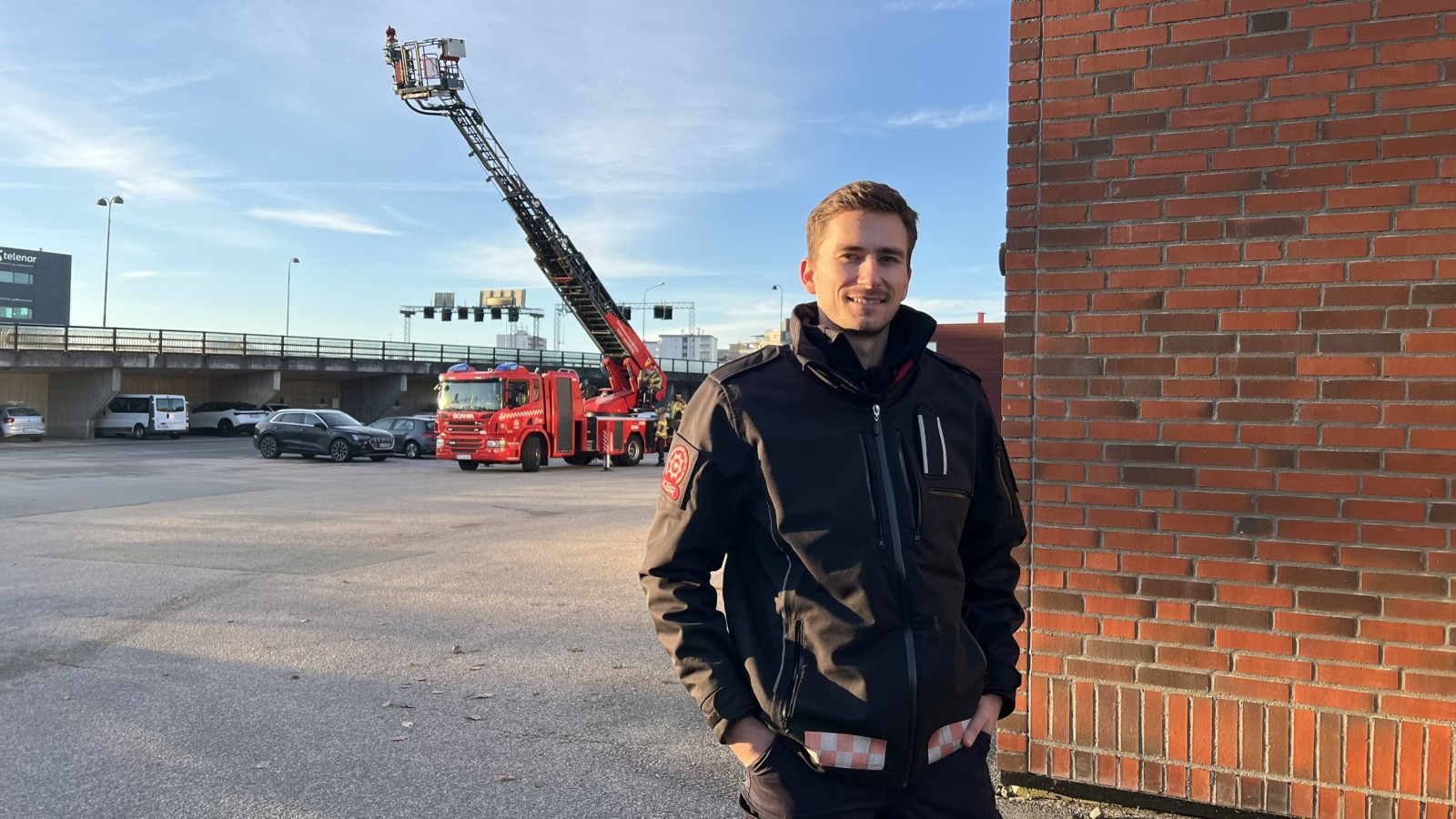 Brannmann i uniform står fremfor brannbil